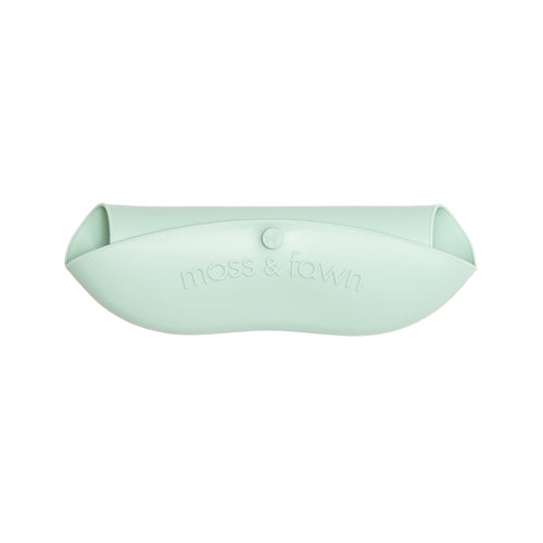 Light green pet bed with 'moss & fawn' branding on a white background
