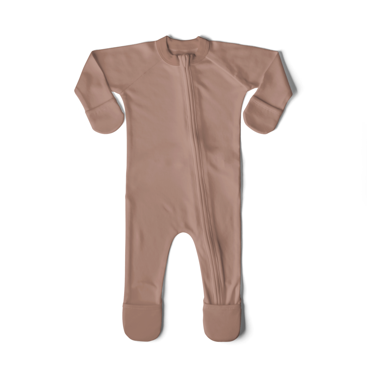 Newborn baby in a pink outfit being held by a person on a textured surface