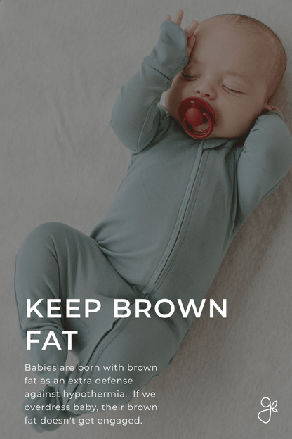 Baby in a light blue onesie with a red pacifier, lying on a neutral background.