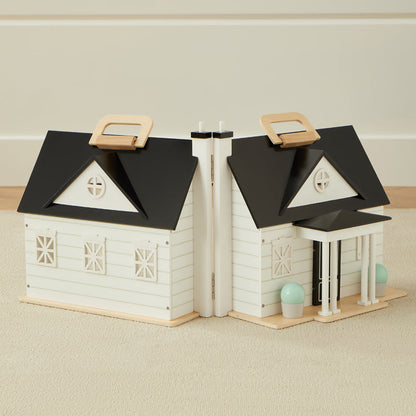 Bookend design resembling a house with black roofs and white bodies on a beige surface.