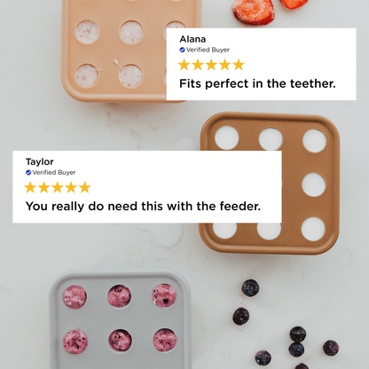 Molded silicone trays with frozen berries on a white surface, featuring customer reviews.