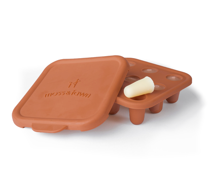 Brown silicone mold with a lid on a white background