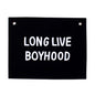 Black sign with white text 'LONG LIVE BOYHOOD' on a white background