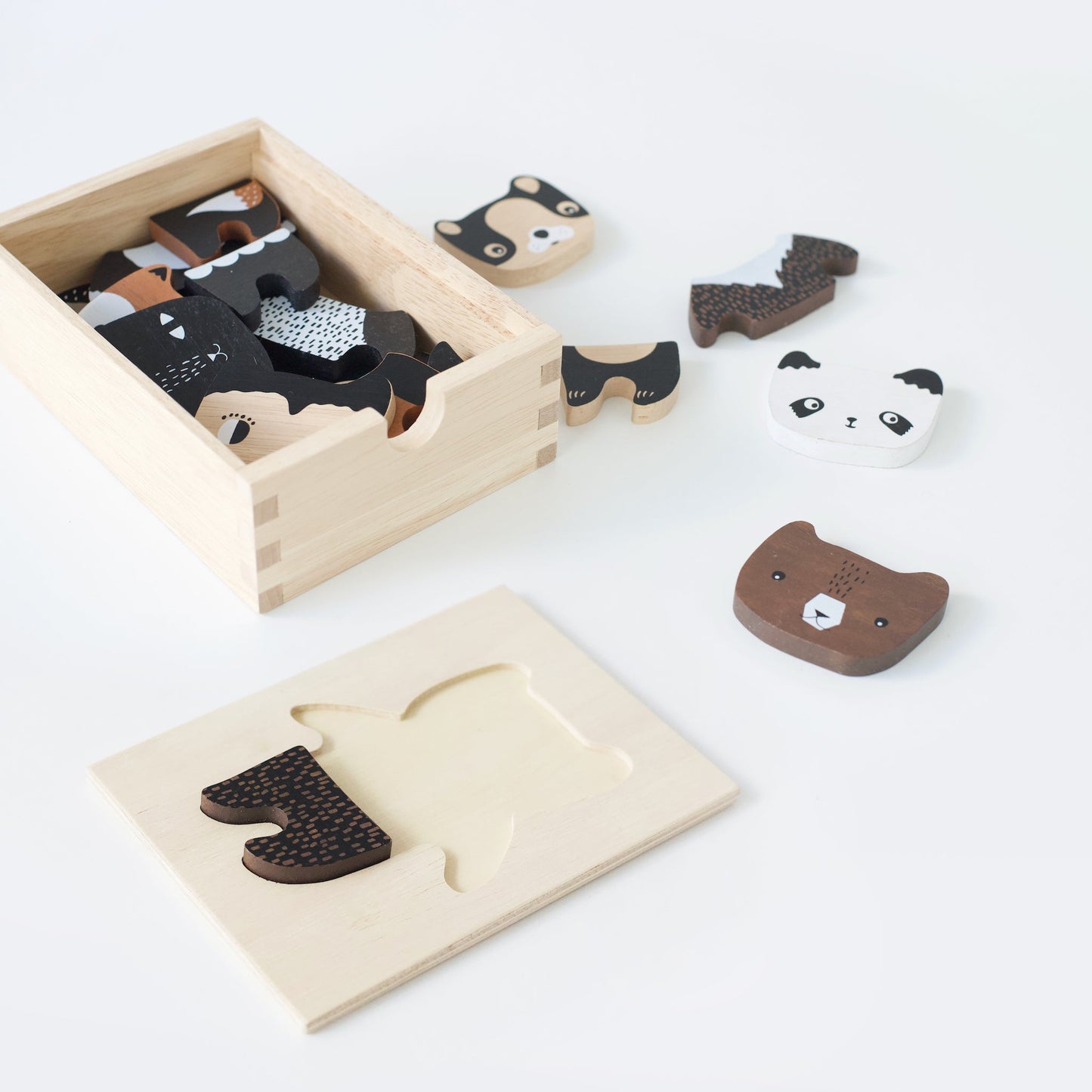 Wooden animal puzzle with pieces on a white background