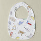 Baby bib with colorful patterns on a beige background