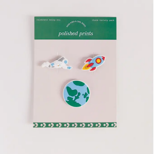 Set of three enamel pins on a 'polished prints' branded card against a light gray background