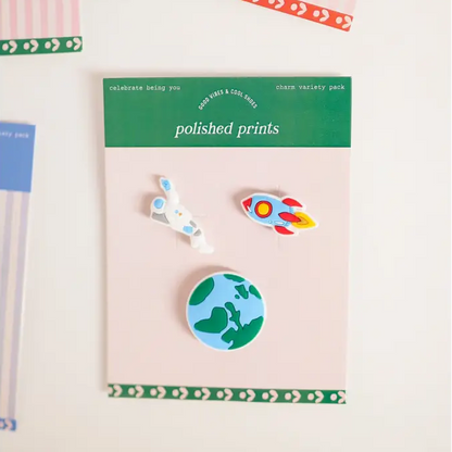 Set of colorful pins on a pink card with 'polished prints' branding.