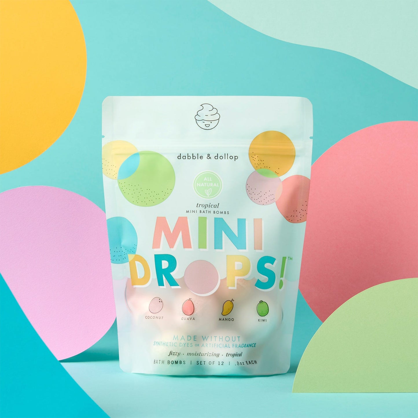 Package of 'Mini Drops' bath bombs with colorful design on a blue background