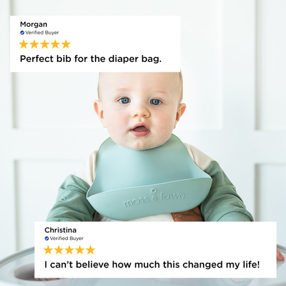 Baby wearing a green bib with positive reviews displayed above