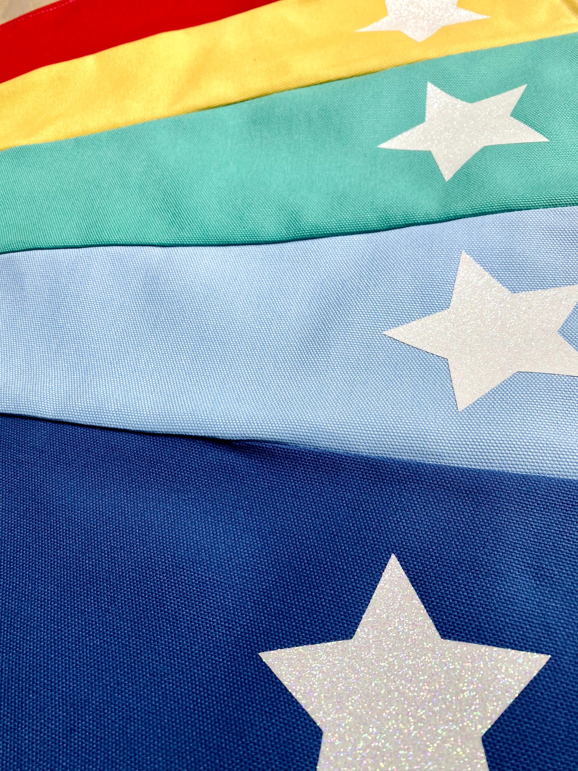 Close-up of a colorful fabric with white stars on a blue background