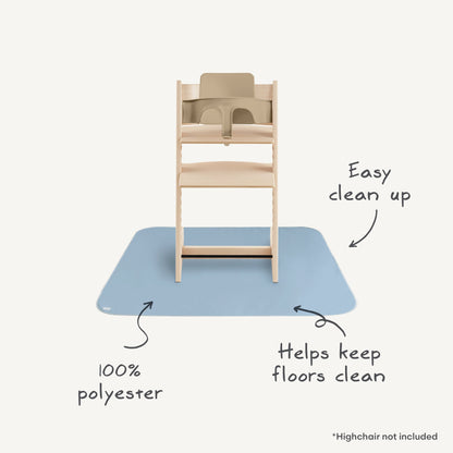 Wooden high chair with a blue mat underneath, labeled for easy clean-up and flooring protection.