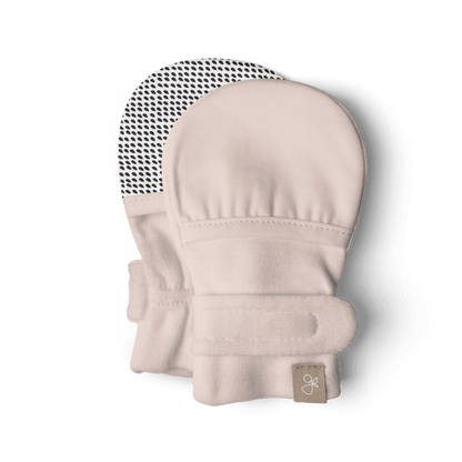 Beige baby mittens with a brand label on a transparent background