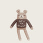 Knitted teddy bear wearing a sweater with 'let's be friends' text on a beige background