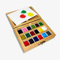 Wooden watercolor paint set with color swatches on a white background