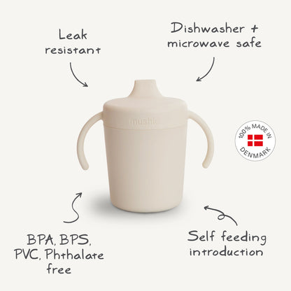 Beige sippy cup with features listed on a white background