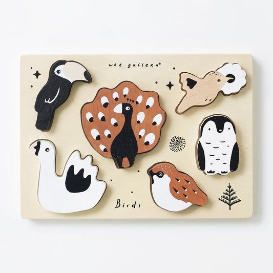 Wooden puzzle with bird shapes on a white background