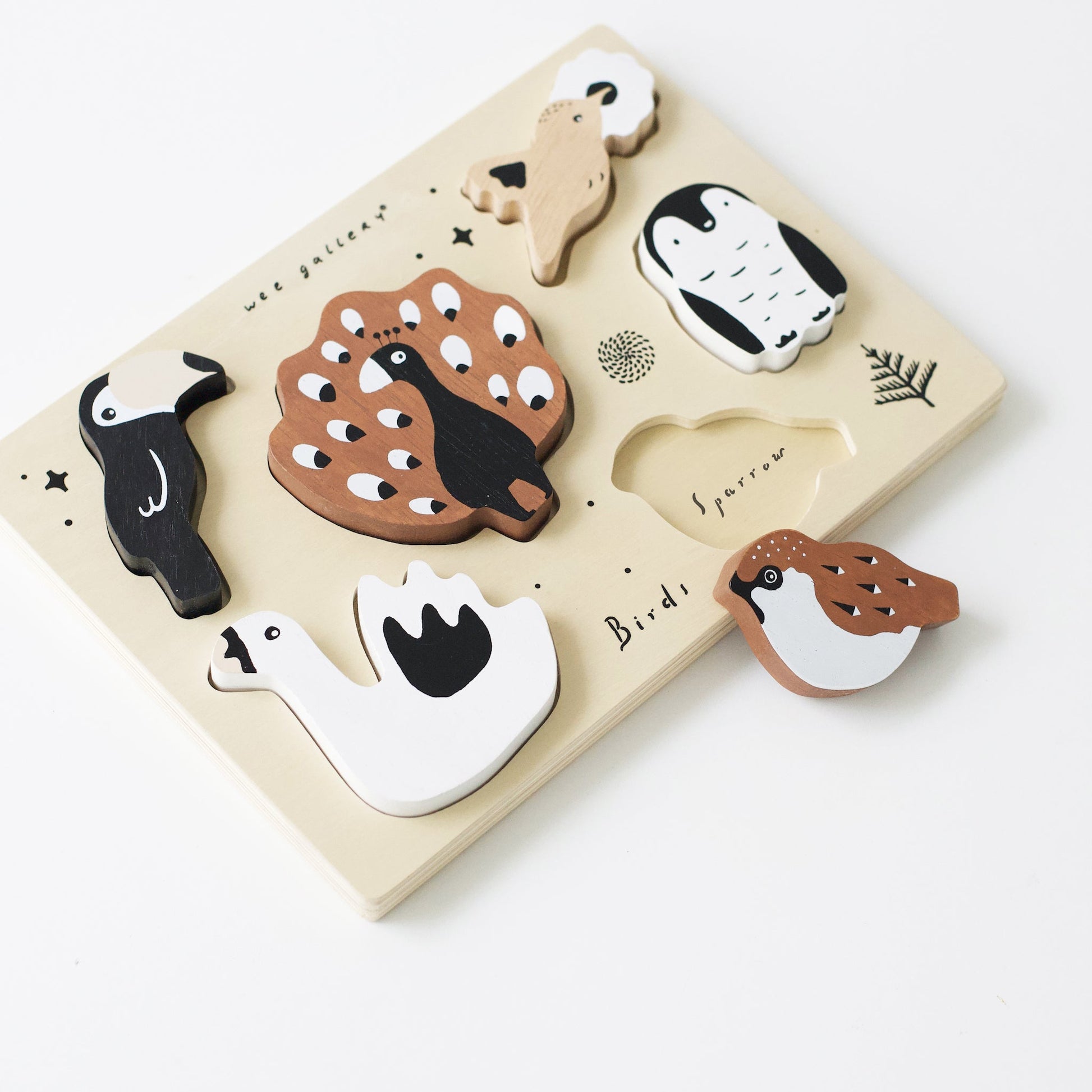 Wooden puzzle with animal shapes on a white background