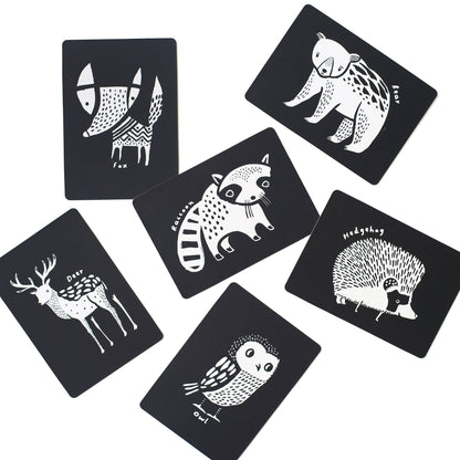 Set of six black cards with white animal illustrations on a white background