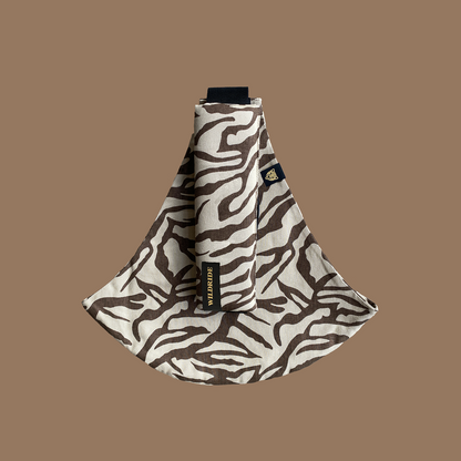Zebra-patterned toddler carrier on a brown background