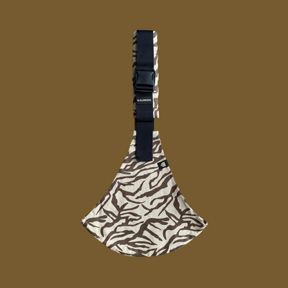 Patterned pouch with a strap on a brown background
